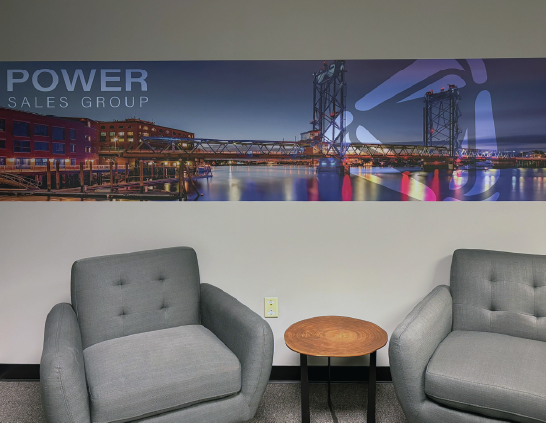entry way vinyl wall graphic over chairs in reception. features logo and brand overlay on portsmouth nh bridge art